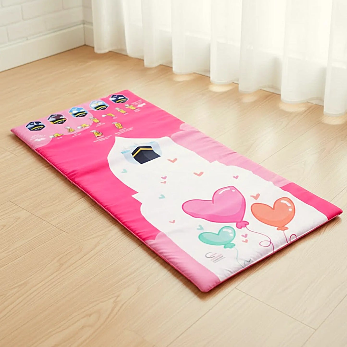 Children's play mat with cartoon designs on a wooden floor.