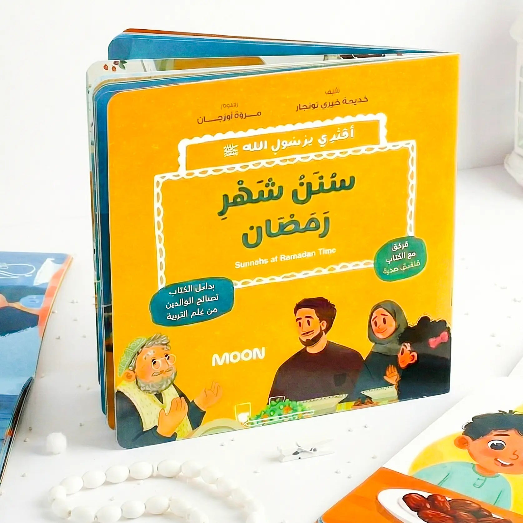 Children's book with Arabic text and illustrations on a white surface
