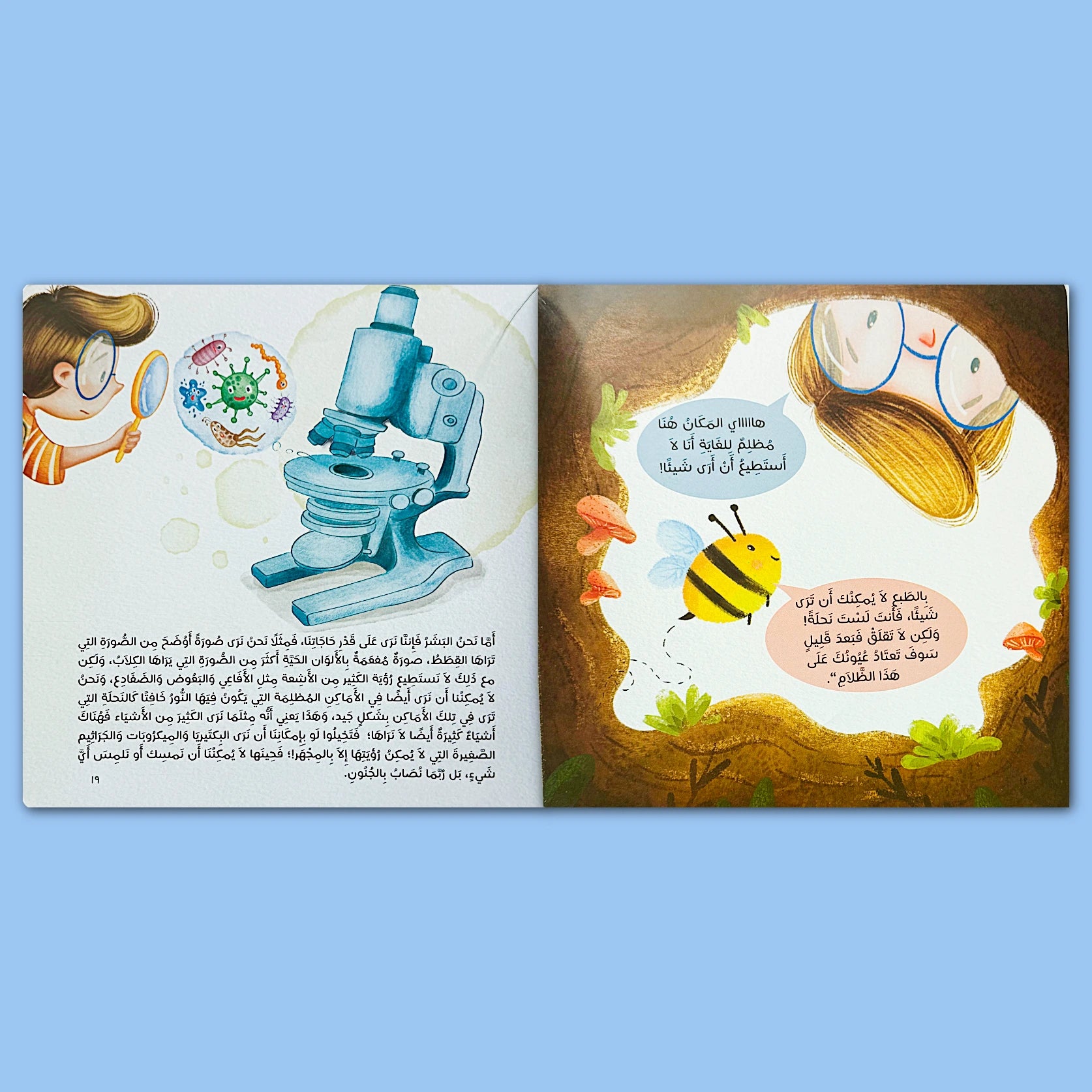 Illustrated book pages with a microscope and a bee on a blue background
